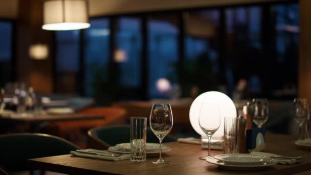 Table de restaurant moderne de l'hôtel dans le café du soir. Femme attendant le dîner romantique — Video