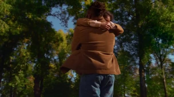 Αγαπημένος μπαμπάς γυρίζοντας παιδί αγκαλιάζει χαρούμενη χαριτωμένο κόρη στο ηλιόλουστο πάρκο άνοιξη. — Αρχείο Βίντεο