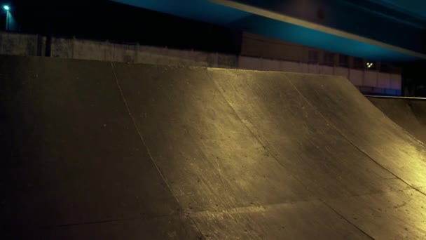 Hombre extremo montando bicicleta bmx por la noche en skatepark urbano. Bmx rider practicando. — Vídeo de stock