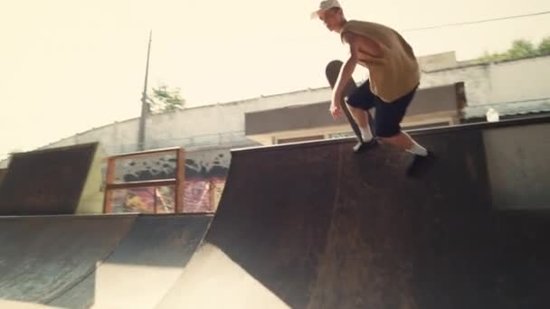 Skateboarder actif échouant tour sur la rampe au skate park. Mode de vie homme extrême. — Video