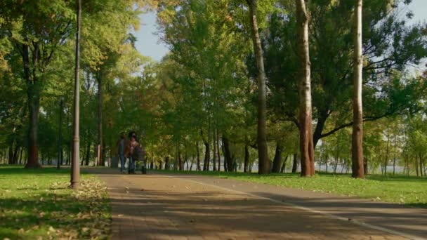 Parque de passeio da família idílica no dia quente do outono. Irmã mais velha cuidar do recém-nascido. — Vídeo de Stock