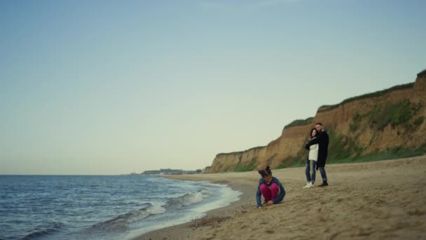 Ung familj njuta av semester på havet strand natur. Barnlek med föräldrar utomhus — Stockvideo