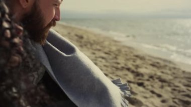 Sahile bakan çok ırklı bir çift. Açık denizde dinlenen düşünceli insanlar..