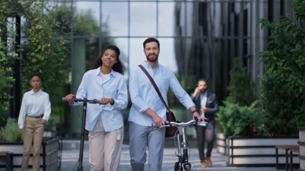 Colegas sorridentes andando conversando no centro da cidade. Cultura ecológica corporativa. — Vídeo de Stock