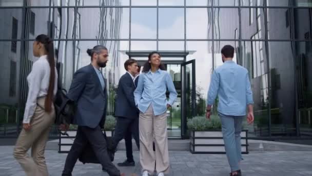 Glimlachende zakenvrouw die zich buiten zelfverzekerd voelt modern glazen gebouw. — Stockvideo