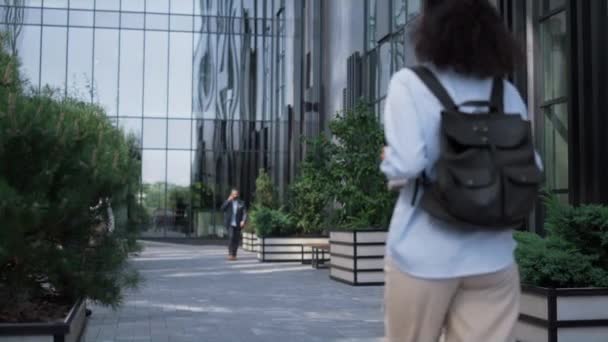 Relaxed businesswoman walking downtown street holding electric scooter rear view — Stock Video