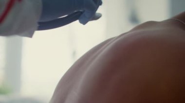 Doktor, bulaşıcı hastalıklar bölümünde steteskopla ciğerleri dinliyor..