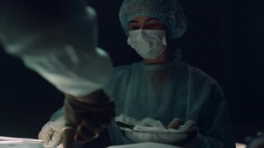 Hemşire asistanı klinik odasında ameliyat pratisyeni. Tıbbi ekip dikiş yarası.