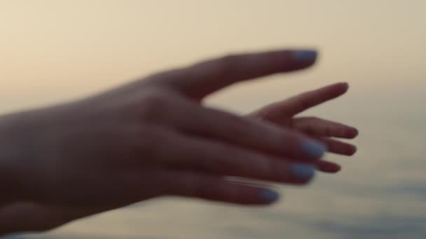 Kvinnliga händer sträcker sig framåt nära havet på nära håll. Flicka som utövar yoga asana. — Stockvideo