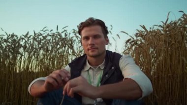 Ciddi bir çiftçinin portresi ekilmiş buğday tarlasında poz veriyor. Yorgun adam, yalnız dinlen..