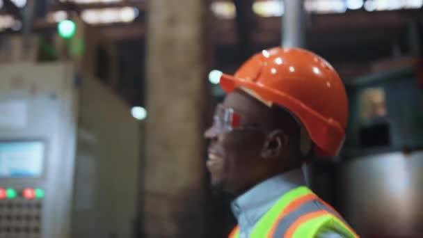 Joyful man engineer smiling at huge modern factory wearing safety uniform. — ストック動画