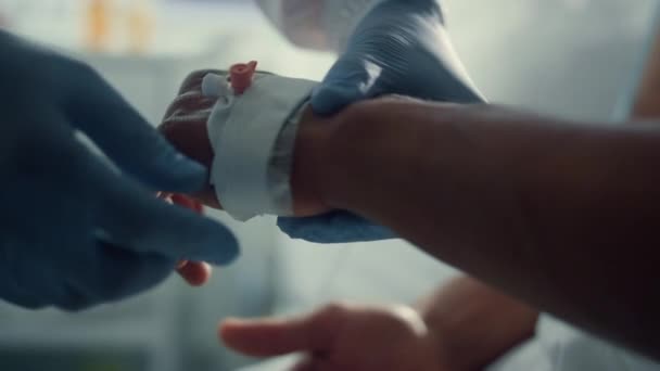 Patient hand with iv catheter closeup. Medical worker preparing drip equipment. — Stock Video