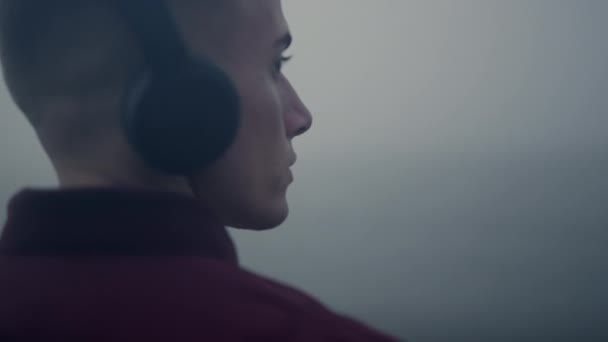 Pensive man listening music headphones closeup. Guy moving head in music rhythm — стоковое видео