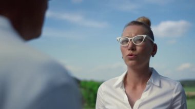 İş kadını golf kulübünün dışında konuşuyor. Ciddi bir bayan sahada sohbet ediyor..