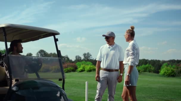 Jugadores de golf grupo charlando juntos en fairway. Golfistas conduciendo carro al aire libre. — Vídeo de stock