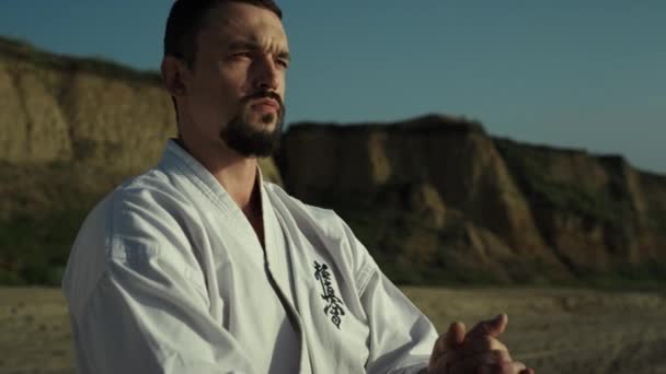 Calm Focused Karate Man Standing Sand Seacoast Training Outdoors Close — Wideo stockowe