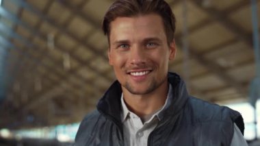 Handsome farmer posing barn portrait. Successful agribusiness owner alone.