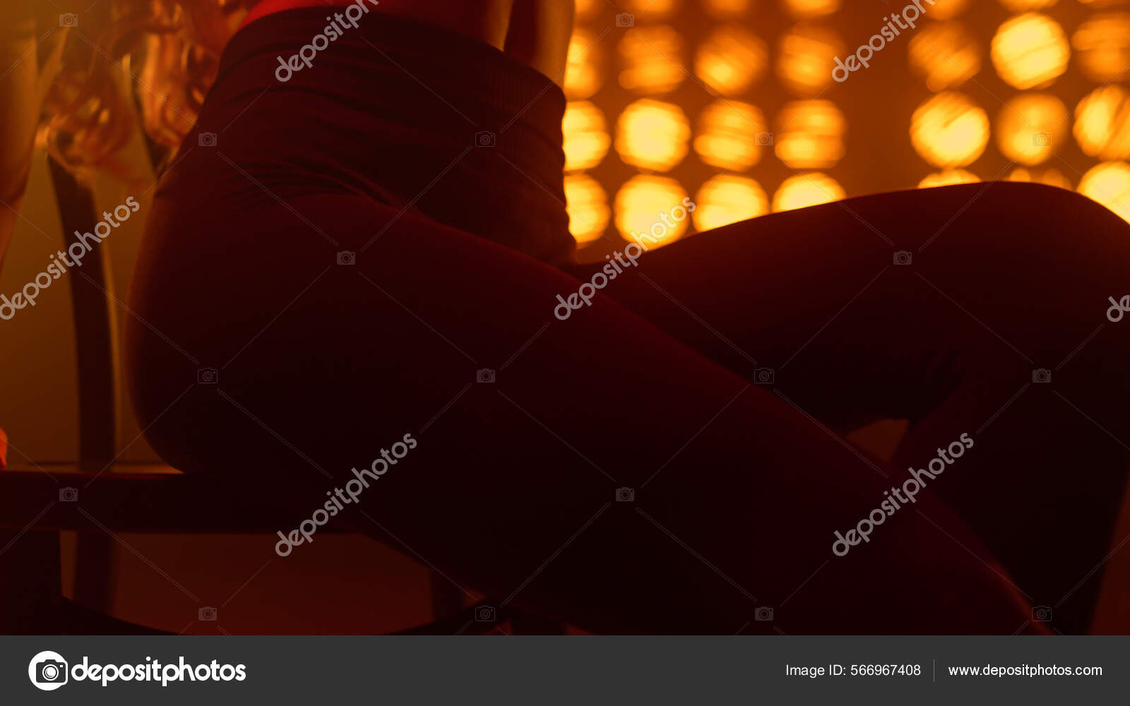 Slim woman legs making sexual movements on nightclub spotlights close up