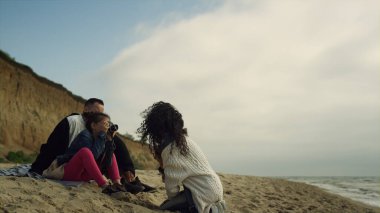 Aileler denizde birlikte plaj fotoğraflarının çekilmesinden hoşlanırlar. Anne, baba, çocuklar dışarıda eğlenin..