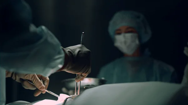 Zbliżenie rąk chirurgicznych przy użyciu przyrządów medycznych do operacji na oddziale szpitalnym. — Zdjęcie stockowe
