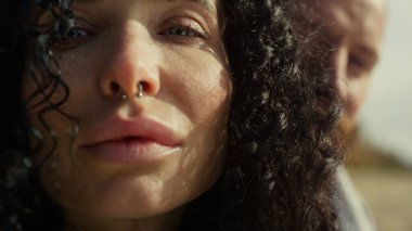 Doğanın arka planına bakan etnik kadın yüzü. Çiftler rüzgarın tadını çıkarır