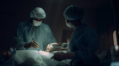 Acil serviste çalışan doktorlar. İşbirlikçi tıp çalışanları hastayı kurtarıyor.