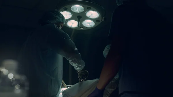 Professional surgeon stitch incision in operating room. Intensive care unit team — ストック写真