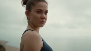 Girl looking camera relaxing on nature close up. Lady practicing yoga outdoors.