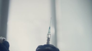 Medicine syringe fulled drug in doctor hands close up. Nurse preparing vaccine.
