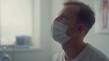Clinic client reporting health complaints to doctor in modern office closeup.