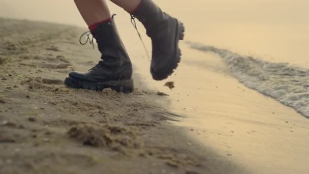 Gros plan jambes de femme dansant sur la plage de sable fin. Fille pieds portant des bottes élégantes — Video
