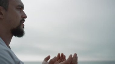Athletic man making hands exercises practicing karate on nature close up.