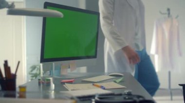 Green screen computer monitor on online meeting doctor working clinic close up.