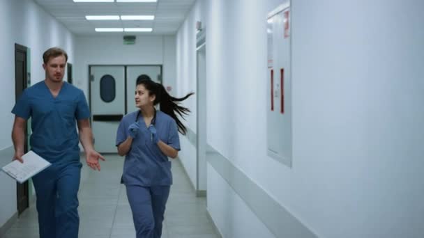 Doctors walking down corridor discussing diagnose. Medics hurrying to operation.