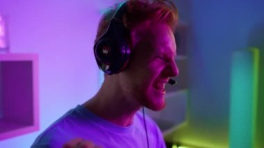 Closeup cyber player celebrating online tournament victory. Excited neon man 