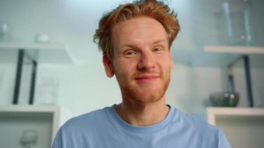 Cheerful man using webcam closeup. Laughing blogger streaming talking at home