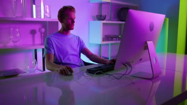 Focused gamer playing video game. Creative architect make project in neon lights — Vídeos de Stock