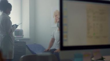 Physician woman discussing disease symptoms patient sitting hospital office.
