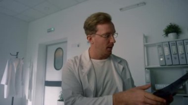 Doctor examining lungs x-ray close up pov video. Physician diagnosing online.