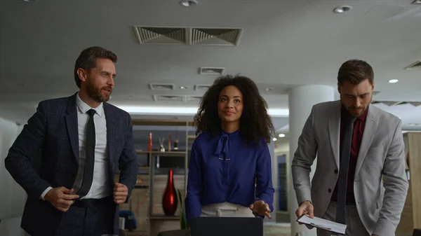 Multiracial business team finishing work conference meeting in office workplace.