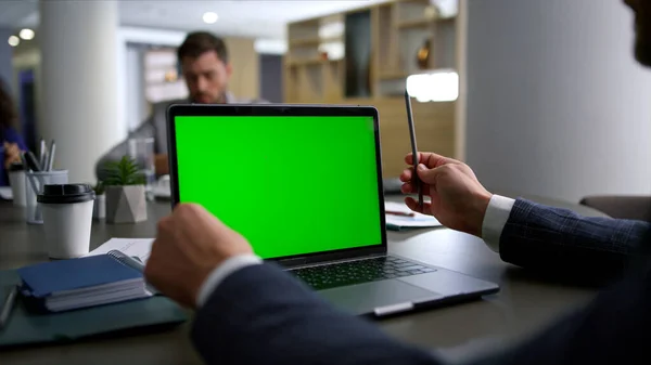 Mãos empresário pesquisando computador laptop tela verde na mesa de conferência. — Fotografia de Stock