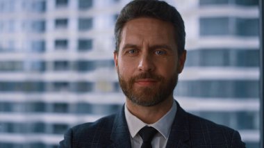 Şirket vitrininde gülümseyen başarılı bir iş adamı..