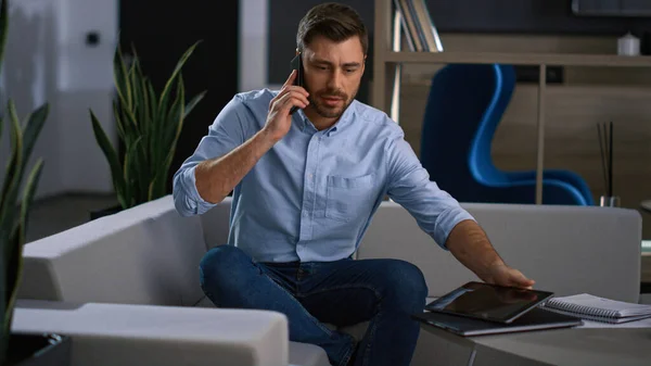 Entrepreneur man phone talking in office. Businessman using laptop searching web