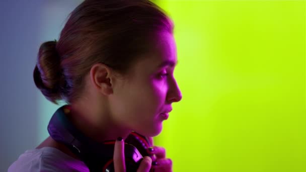 Cyber gamer putting headset in neon room closeup. Esport professional preparing — Stock Video