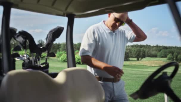 Golfspelers team rijden golfkarretje buiten. Paar genieten van warme zomervakantie. — Stockvideo