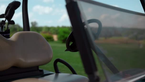 Golf cart driving seat at country club meadow. Sport equipment by car wheel. — Stock Video