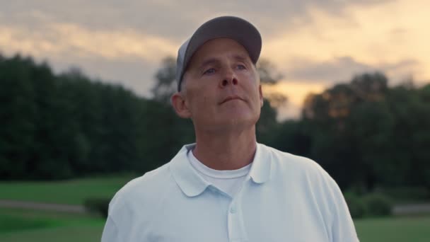 Senior golfspelare vilar på solnedgången natur. Aktiva äldre står på sommarkurs. — Stockvideo