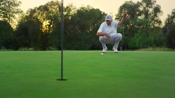 Jugador de golf buscando campo en el campo de hierba exuberante. Entrenador de golf sentarse en fairway juego — Vídeo de stock