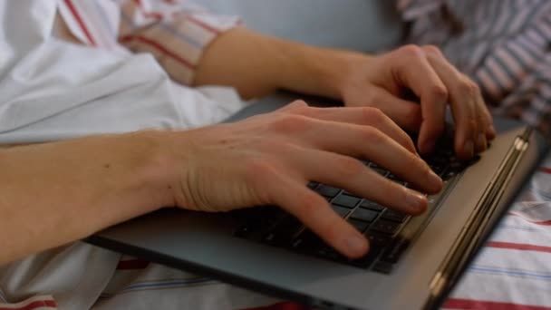 フリーランサーの手はパジャマのクローズアップでノートパソコンのキーボードを入力します 発表会の準備をしてる男だ 知られていないビジネスマンのブラウジングウェブは週末に電子メールを送る コンピュータを使って勉強する忙しい学生 — ストック動画