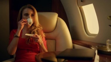 Çekici kadın altın güneş ışığında kahveden zevk alıyor. Tatilde seyahat eden lüks bayan dinlenme uçağı. Düşünceli iş kadını özel jetle tek başına uçuyor. Gülümseyen eş, mutlu sıcak anları hatırlıyor.